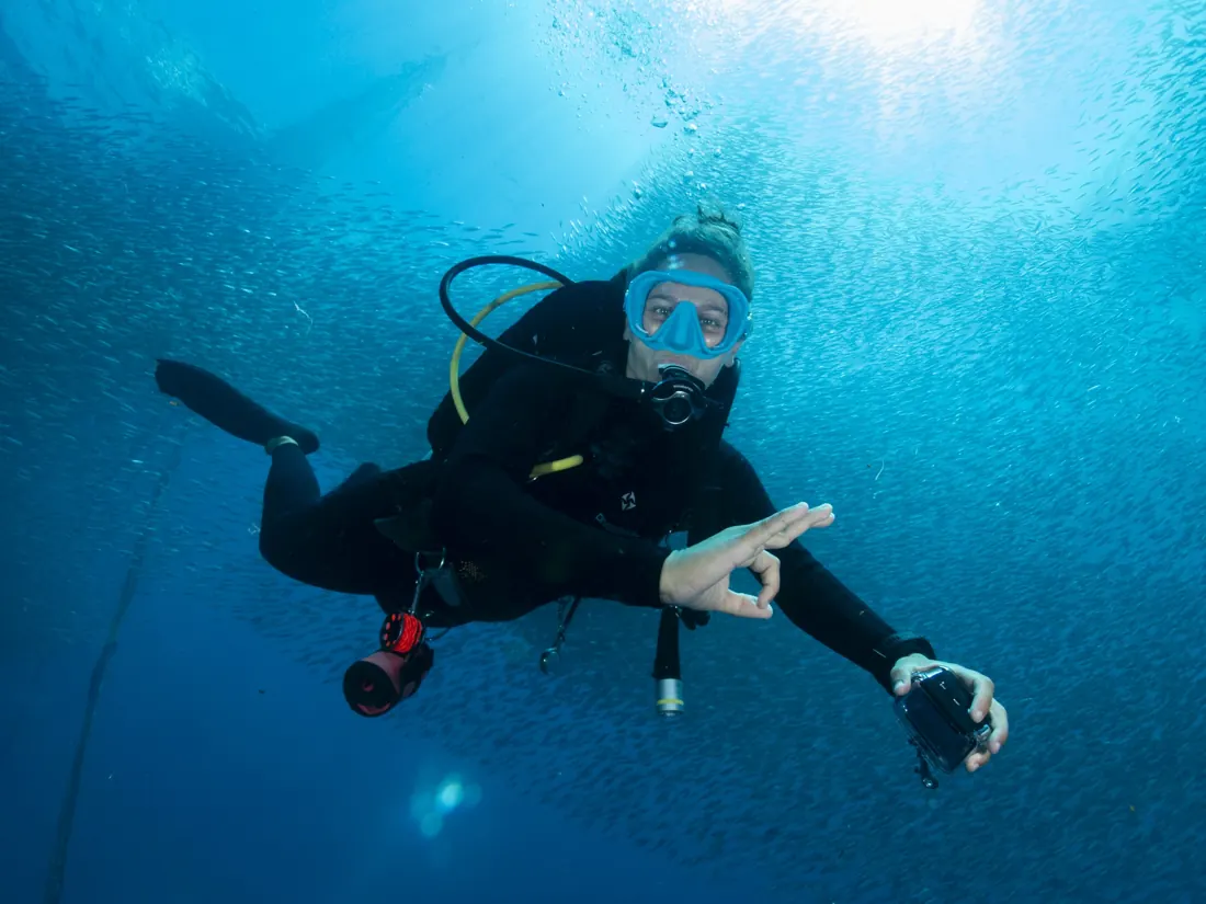 A dive guide making the OK sign
